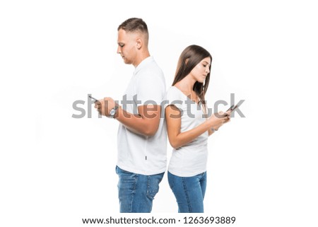 Happy couple looking at smartphone isolated on gray background