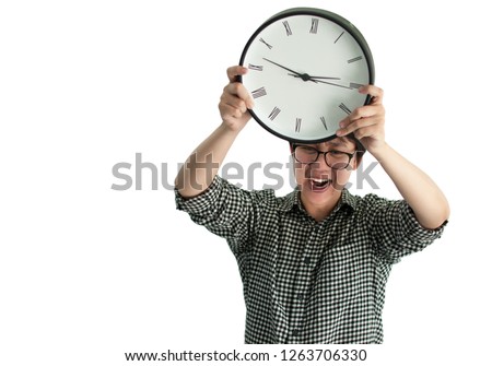 Angry person screaming, holding clock in both hand try to throw it away isolated on white background with copy space. Portrait of model throwing clock with aggressive expression. Deadline timing c