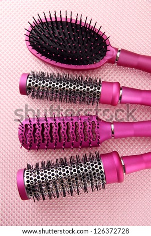 Comb brushes on pink background