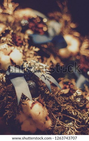 Christmas wreath of cones. florist hands taking Christmas wreath 