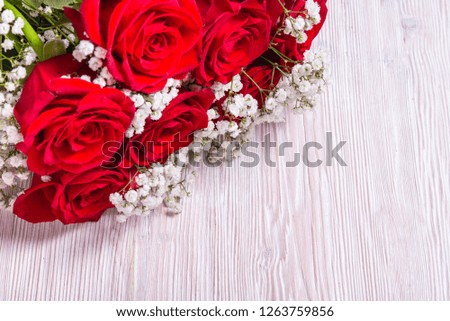 Bouquet of roses on wooden background