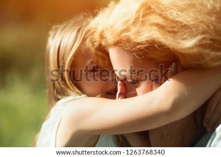 Bright Portrait. Cute Blonde Girl Hugs Tight Her Mother Who Is Crying From Happiness. Portrait Of Disabled Woman Crying When Being Hugged By Daughter