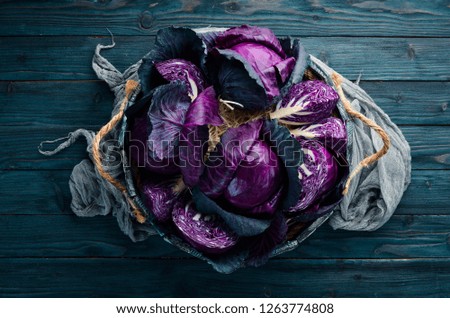 Purple cabbage in a wooden box. Organic food. Top view. Free space for your text.