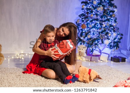 mother and son open Gifts Christmas New Year holiday Garland lights