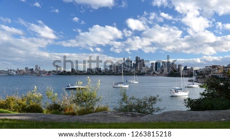 Sydney cityscape of Sydney CBD with yachts over Sydney Harbour on a sunny cloudy day. View from Cremorne Point. 
