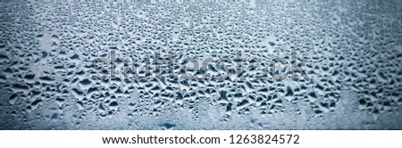 Drops on the glass. Blurred window. Abstract background