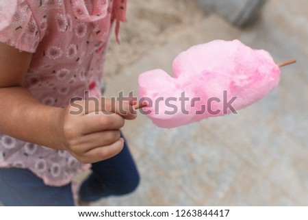body parts. girl holding pink cotton candy