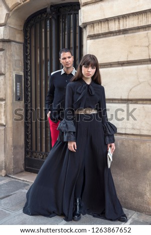 Street fashion concept. Portrait of elegant young couple. Paris buildings as background.