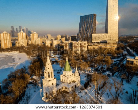 Aerial view of the old Christian Orthodox church in Moscow on the background of a modern residential skyscraper
