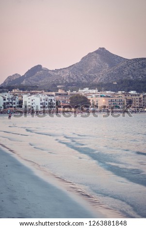 Port of Alcudia beach at sunset, color toned picture, Majorca, Spain.