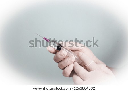 Hands and syringe