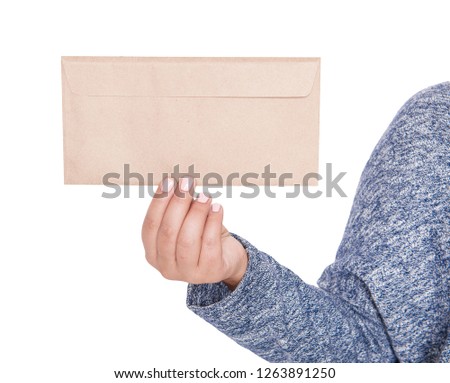 Woman hand holding blank paper envelope isolated. Mockup for design