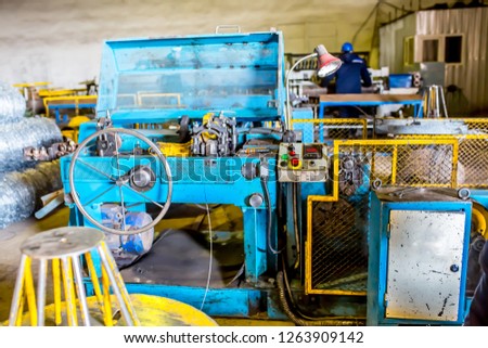Metal rolling industrial workshop. Craftsmen working on metal rolling machines. Industrial modern technology.Technological work on the production of metal structures.Working atmosphere with copy space