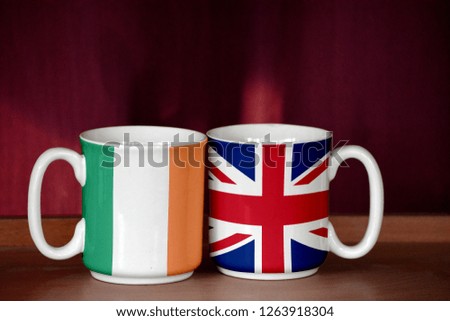 United Kingdom and Ireland flag on two cups with blurry background