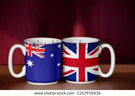 United Kingdom and Australia flag on two cups with blurry background