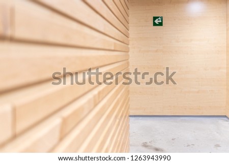 Exit sign on top of a wooden wall.
