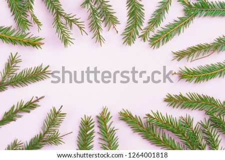 Christmas composition. Creative layout fir green branches on white background. Square frame with christmas tree branch. Flat lay, top view, copy space. Funky neon colors, trendy minimal concept.