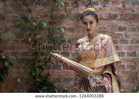 Beautiful Thai woman in traditional classic dress costume with thai indentity culture of Thailand.