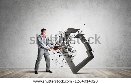 Determined businessman jumping and breaking with violin house concrete figure