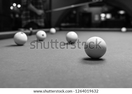 The game of American and Russian billiards. Pool table, ball and cue. Sports leisure. Friendly tournament. Winter fun. Green cloth in billiards. Luza for the ball. Aim and beat. Cue kick.