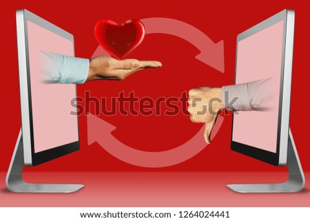 technology concept, hands from laptops. heart and thumbs down, dislike