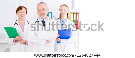 doctor posing with medical staff,nurse in office and copy space, banner of billboard