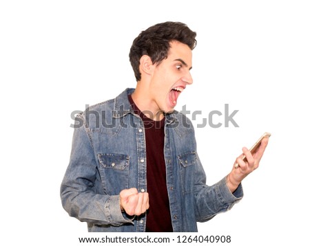 portrait of an angry young man shouting using a mobile over a white background
