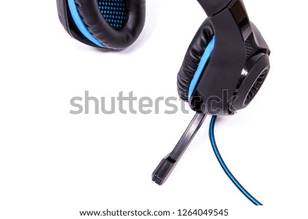 fragment of headphones for a computer in a modern style of black and blue with a microphone on a white background