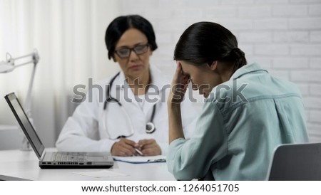 Female doctor informs about bad diagnosis, patient upset incurable disease Royalty-Free Stock Photo #1264051705