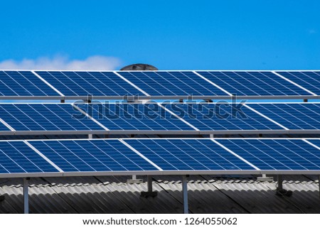 Solar panels closeup on blue sky background .