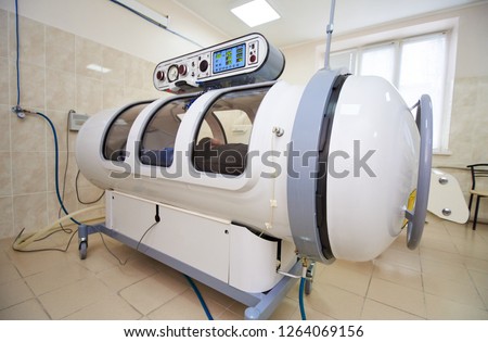 the guy in the black T-shirt lies in the hyperbaric chamber, oxygen therapy, medical room Royalty-Free Stock Photo #1264069156