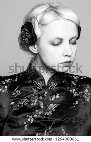 Black and white retro portrait of a girl in a Chinese dress