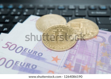 Golden Bitcoin on Euro Banknote. Symbolic image of virtual currency. Business concept of worldwide cryptocurrency.