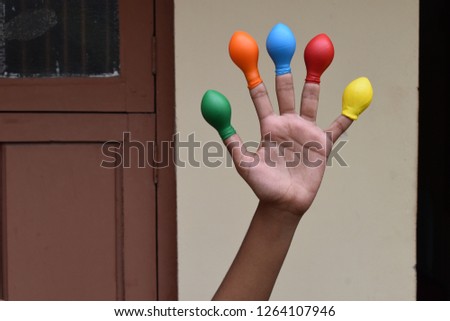 Balloon on finger or kids wearing balloon on fingers 