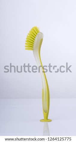 Plastic cleaning brush on white background