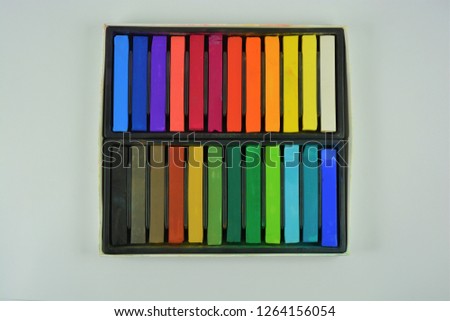 Pastel crayons in a box on a white background