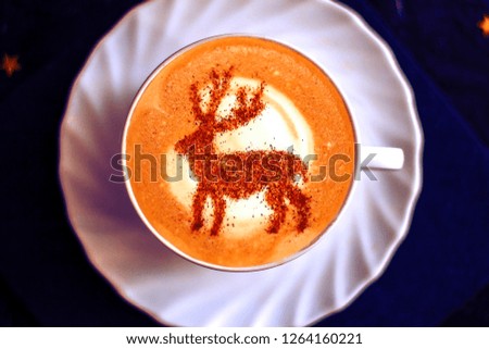 coffee cappuccino with cinnamon Christmas deer pattern on milk foam
