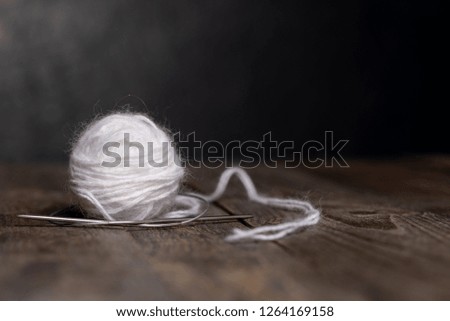 balls of yarn on a dark wooden background