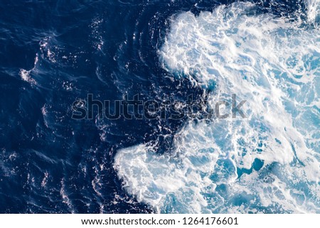AERIAL VIEW OF SEA WITH WAVES AND BLUE DARK WATER Royalty-Free Stock Photo #1264176601