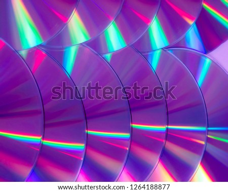 Close up group of violet and purple DVD discs. Background from colorful compact disks.