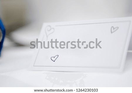 An empty blank paper table card name plate sign on a wedding table,  shot with a shallow depth of field. perfect for placing names in composite designs.