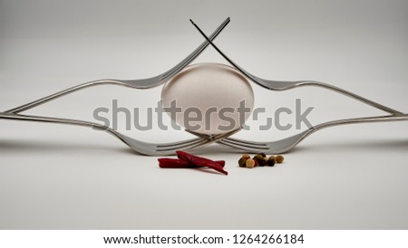 Eggs with chilli draped on cutlery