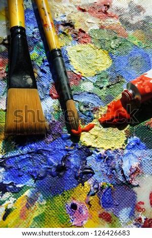 Mixing paintings and paintbrushes lying on the art palette