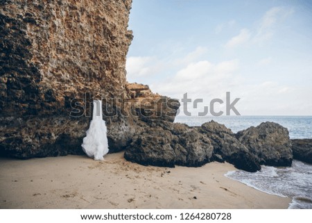 Wedding concept. Bridal wedding hugging on the rock of beautiful tropical beach.