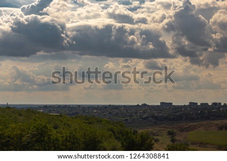 The sky is covered with heavy clouds before a thunderstorm. The outskirts of a small town in the Republic of Moldova. The terrain in southern Europe. Budzhak steppe on the eve of natural disasters.