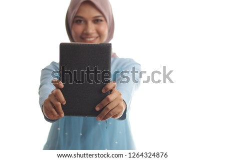 Hijab girl looking pretty holding a book. Education concept. Business women concept. Hijab girl in stylish fashion shoot. Beautiful teacher wearing hijab.