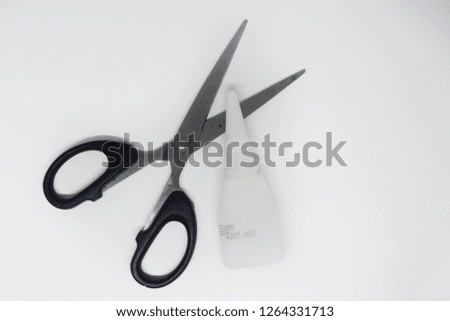 scissors and glue on a white background