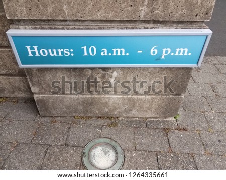 blue hours 10 to 6 sign on grey cement wall