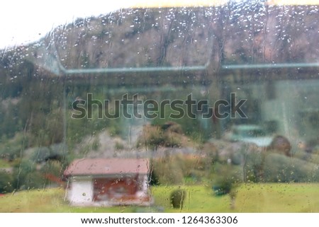 Sweet house through the window in raining day