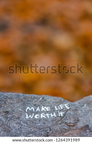 Make life worth it written on rock with copy space